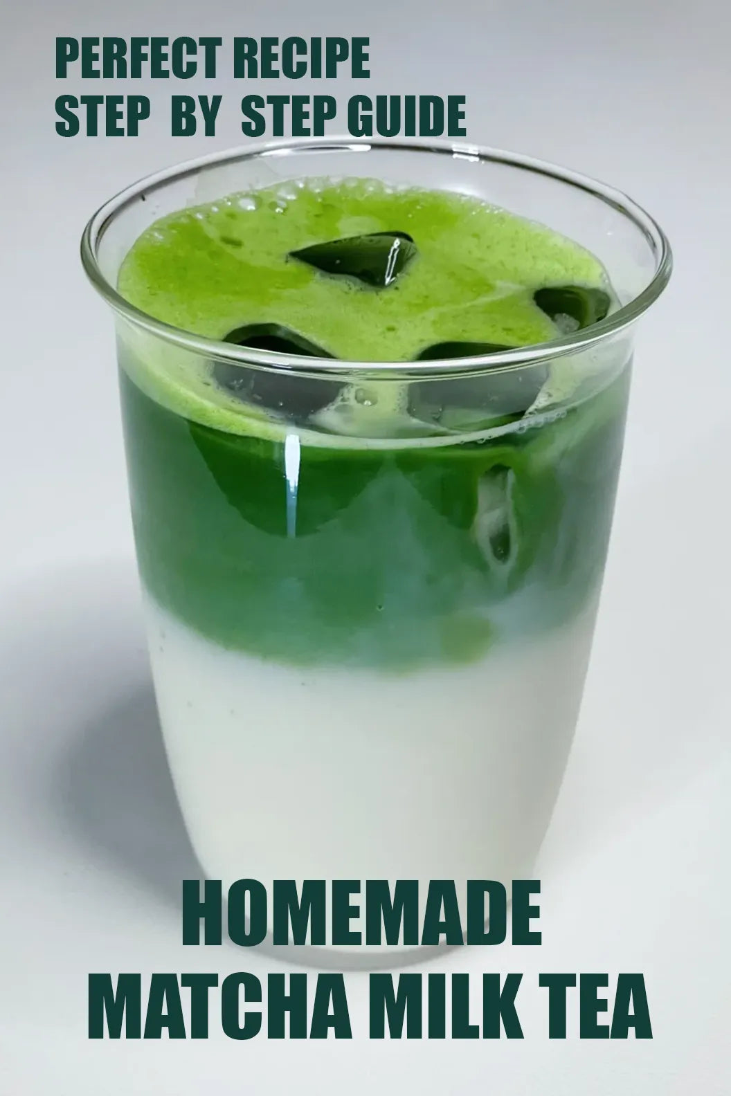 Layered homemade matcha milk tea in a clear glass, with vibrant green matcha top, creamy white milk base, and ice cubes — visual guide for the perfect recipe.