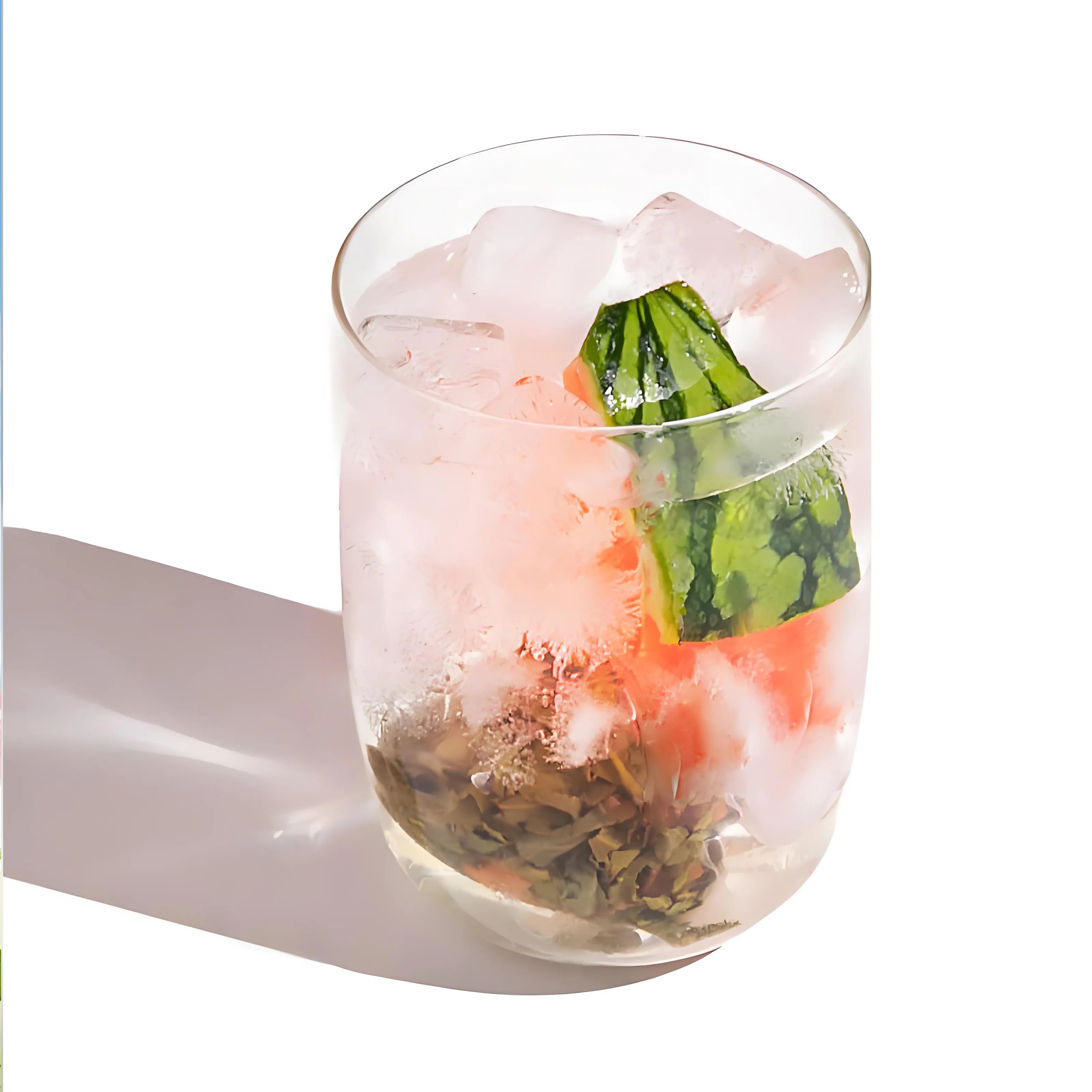 Glass of iced Watermelon Oolong Cold Brew Tea with watermelon cubes and oolong tea leaves, served cold and fresh.