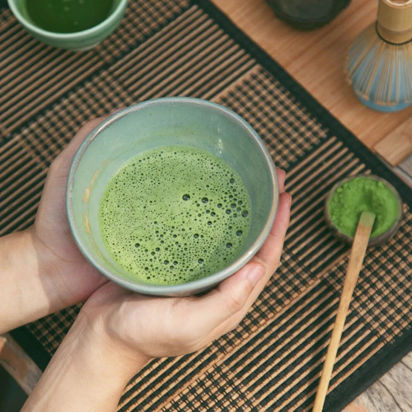 Step three of traditional matcha preparation – freshly whisked matcha tea with a rich frothy layer, ready to serve in a chawan bowl