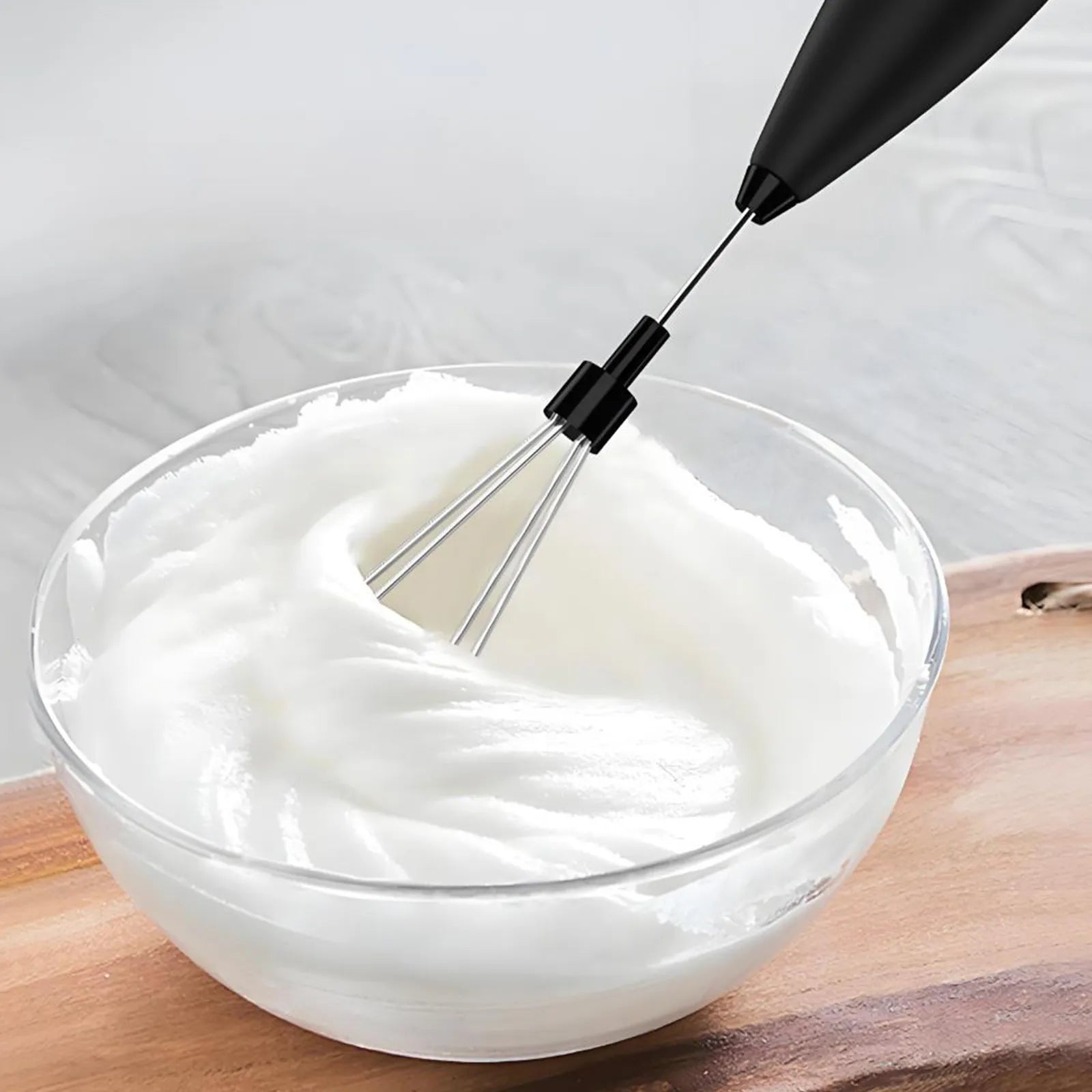 Leafmill electric whisk blending cream in a glass bowl for dessert or drinks