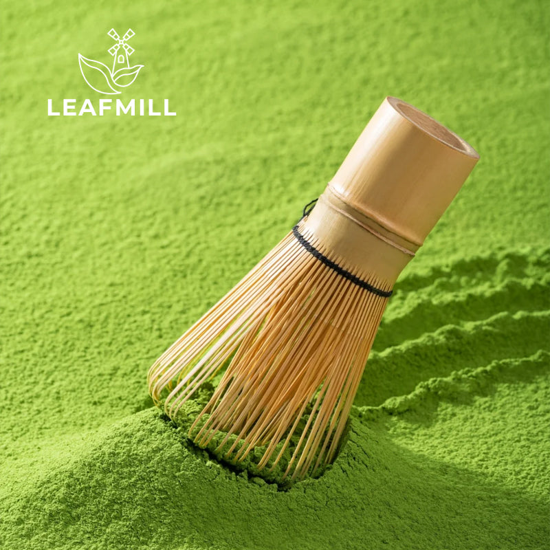 Traditional bamboo whisk resting on ceremonial grade Leafmill matcha powder – premium green tea craftsmanship