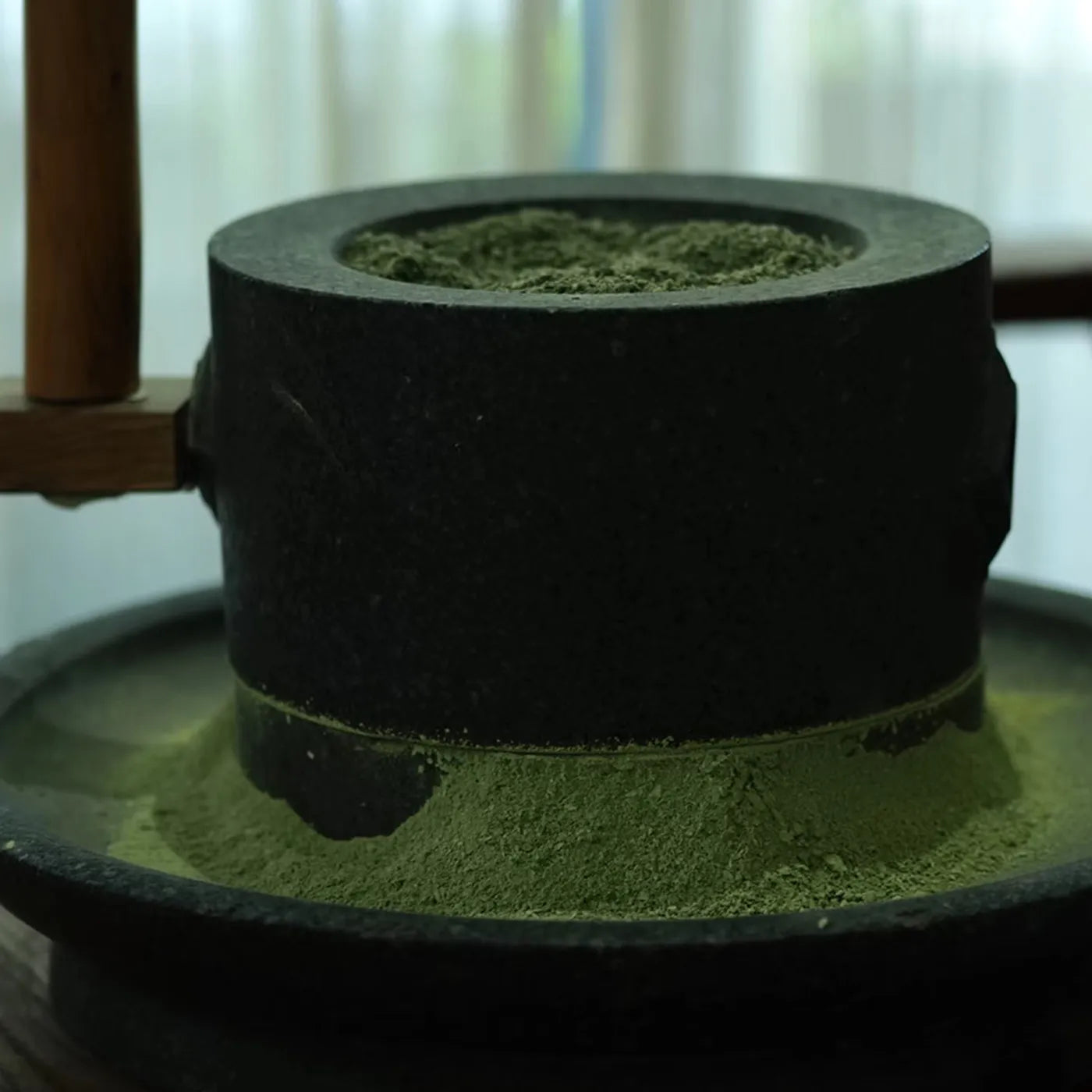 Traditional stone mill grinding fresh matcha powder at Leafmill, preserving aroma and nutrients through slow, low-temperature milling.